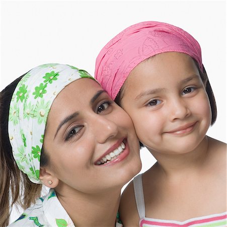 simsearch:630-02221079,k - Portrait of a young woman cheek to cheek with her daughter and smiling Foto de stock - Sin royalties Premium, Código: 630-02220689