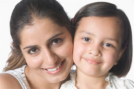 simsearch:630-02221079,k - Portrait of a young woman cheek to cheek with her daughter and smiling Foto de stock - Sin royalties Premium, Código: 630-02220690