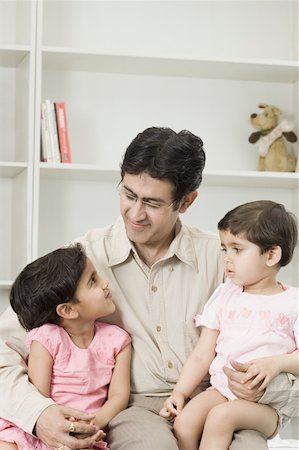 simsearch:630-02220024,k - Mid adult man sitting with his two daughters Stock Photo - Premium Royalty-Free, Code: 630-02220757