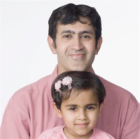 simsearch:630-02220906,k - Portrait of a mid adult man smiling with his daughter Stock Photo - Premium Royalty-Free, Code: 630-02220761