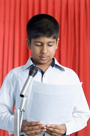 Boy giving an speech on a stage Stock Photo - Premium Royalty-Free, Code: 630-02220775