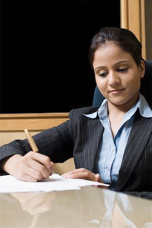 Businesswoman working in an office Stock Photo - Premium Royalty-Free, Code: 630-02220801