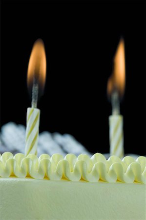 Close-up of lit candles on a birthday cake Stock Photo - Premium Royalty-Free, Code: 630-02220858