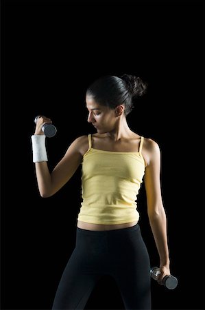 simsearch:630-02219691,k - Young woman exercising with dumbbells Foto de stock - Sin royalties Premium, Código: 630-02220850