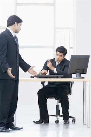simsearch:630-02219583,k - Two businessmen discussing in an office Stock Photo - Premium Royalty-Free, Code: 630-02220853