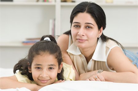 portrait of family lying down side by side - Portrait of a mid adult woman lying on the bed Stock Photo - Premium Royalty-Free, Code: 630-02220893