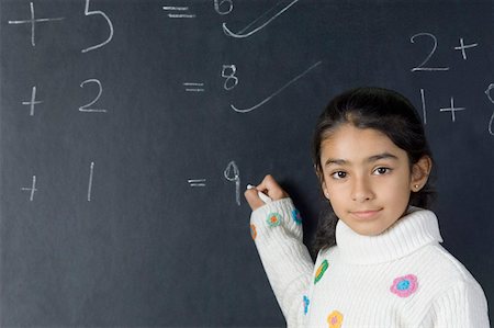 simsearch:640-03265213,k - Portrait of a girl solving mathematical symbols on a blackboard Foto de stock - Sin royalties Premium, Código: 630-02220918