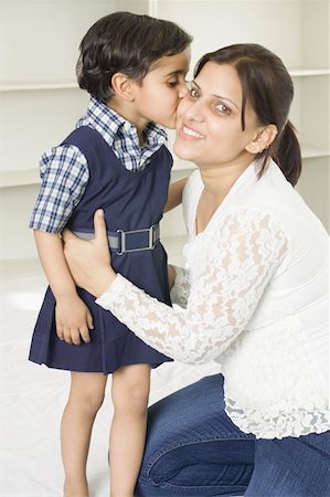 Side profile of a girl kissing her mother Stock Photo - Premium Royalty-Free, Code: 630-02220938