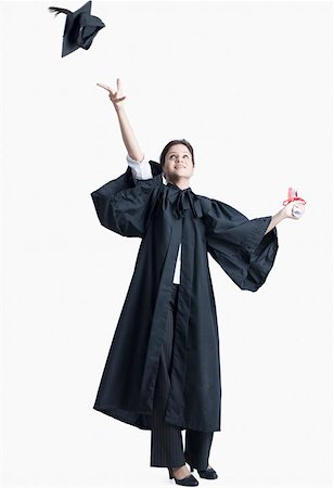 Young female graduate throwing her mortar board in the air Stock Photo - Premium Royalty-Free, Code: 630-02220989