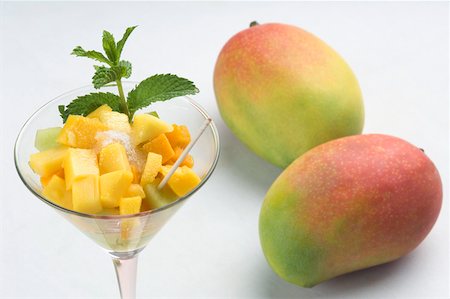 salads and desserts - Close-up of a glass of mango slices and melon slices with mangoes Stock Photo - Premium Royalty-Free, Code: 630-02221021