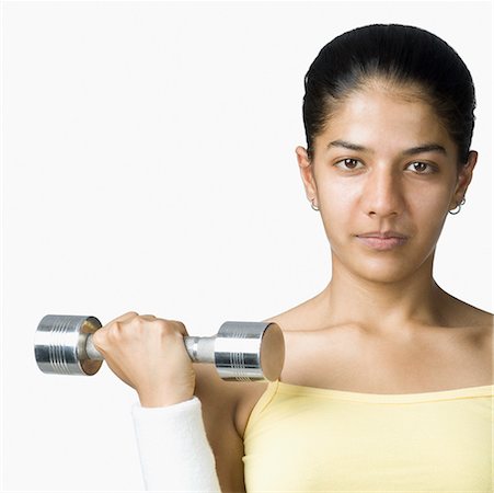 simsearch:630-02219691,k - Young woman exercising with a dumbbell Foto de stock - Sin royalties Premium, Código: 630-02221044
