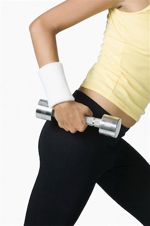 exercise indian women pic - Mid section view of a young woman holding a dumbbell Stock Photo - Premium Royalty-Free, Code: 630-02221046