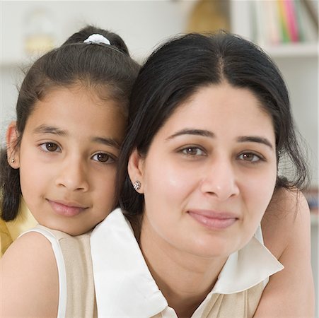 simsearch:630-02219353,k - Close-up of a girl hugging her mother from behind Stock Photo - Premium Royalty-Free, Code: 630-02221105