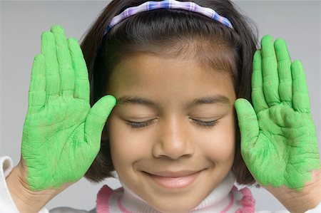 Close-up of a girl showing her painted palms Stock Photo - Premium Royalty-Free, Code: 630-02221121