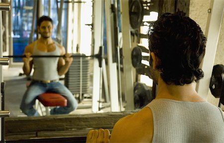 simsearch:630-02219691,k - Rear view of a young man exercising in a gym Foto de stock - Sin royalties Premium, Código: 630-02221144