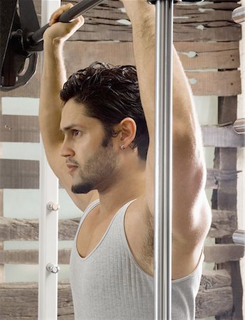 Side profile of a young man exercising in a gym Stock Photo - Premium Royalty-Free, Code: 630-02221156