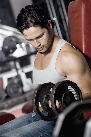 simsearch:630-02219691,k - Side profile of a young man exercising with dumbbells in a gym Foto de stock - Sin royalties Premium, Código: 630-02221160