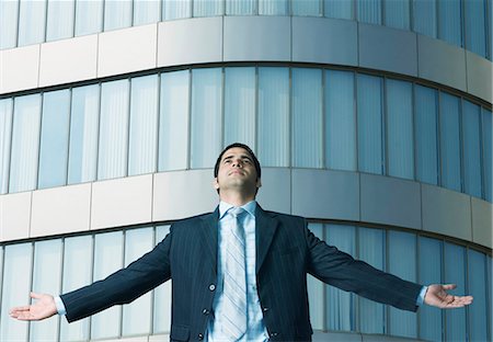 Close-up of a businessman with his arms outstretched Stock Photo - Premium Royalty-Free, Code: 630-03479302