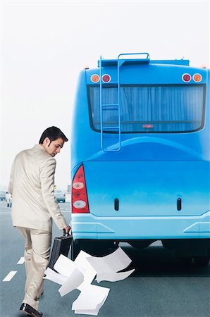 road worker - Documents falling down from the briefcase of a businessman Stock Photo - Premium Royalty-Free, Code: 630-03479323