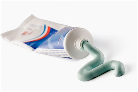 squeezing - Close-up of a toothpaste tube Stock Photo - Premium Royalty-Free, Code: 630-03479371