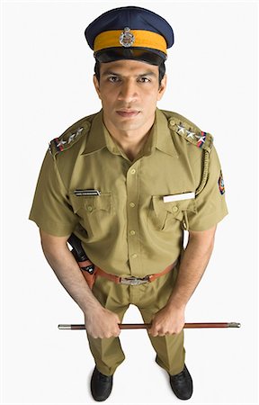 Portrait of a policeman holding a nightstick Stock Photo - Premium Royalty-Free, Code: 630-03479403