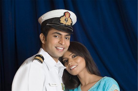 Close-up of a navy officer smiling with a teenage girl Stock Photo - Premium Royalty-Free, Code: 630-03479433