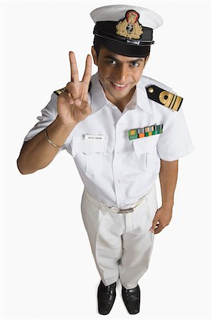 simsearch:630-06723471,k - Portrait of a navy officer showing a victory sign Stock Photo - Premium Royalty-Free, Code: 630-03479470