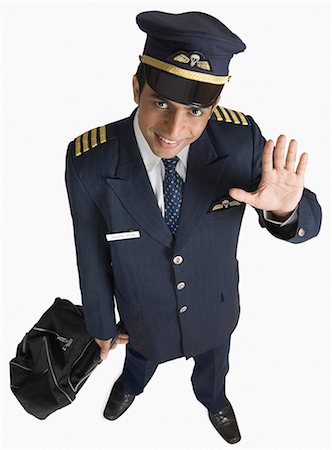 Portrait of a pilot carrying his luggage Stock Photo - Premium Royalty-Free, Code: 630-03479536