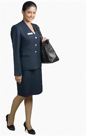 Portrait of an air hostess smiling Foto de stock - Sin royalties Premium, Código: 630-03479545