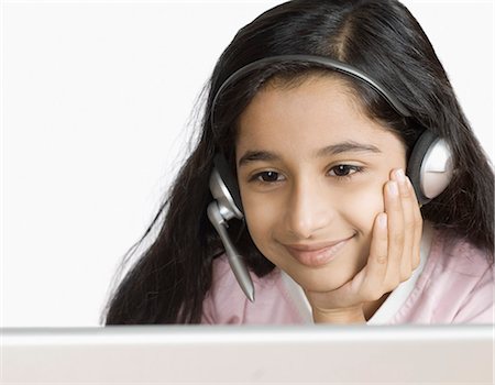 Girl chatting online and smiling Stock Photo - Premium Royalty-Free, Code: 630-03479581