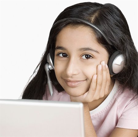 Girl chatting online and smiling Stock Photo - Premium Royalty-Free, Code: 630-03479582