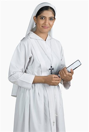 photography images indian women traditional - Portrait of a nun holding the Bible Stock Photo - Premium Royalty-Free, Code: 630-03479668