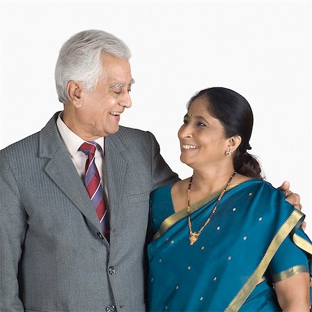 senior formal - Senior man standing with his arm around a mature woman and smiling Stock Photo - Premium Royalty-Free, Code: 630-03479677