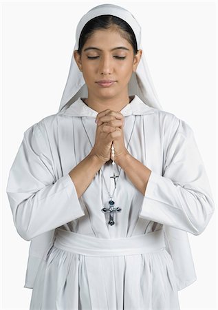 Close-up of a nun standing in the prayer position Stock Photo - Premium Royalty-Free, Code: 630-03479671