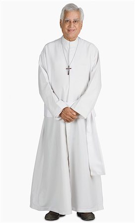 portrait full body 50s studio - Portrait of a priest smiling Stock Photo - Premium Royalty-Free, Code: 630-03479685