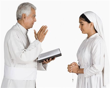 religion sign - Nun confessing her sins to a priest Stock Photo - Premium Royalty-Free, Code: 630-03479697