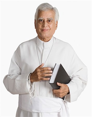 portrait of asian male senior - Portrait of a priest holding the Bible and smiling Stock Photo - Premium Royalty-Free, Code: 630-03479698