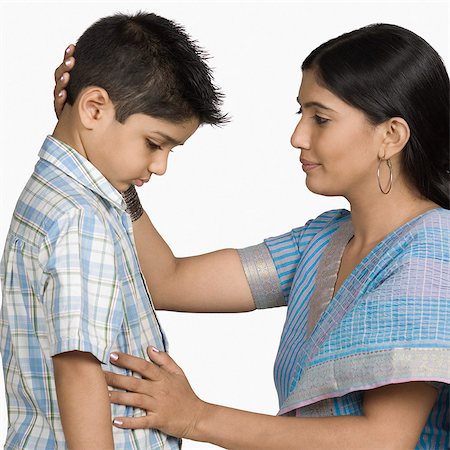 sad indian woman images - Side profile of a young woman consoling her son Stock Photo - Premium Royalty-Free, Code: 630-03479750