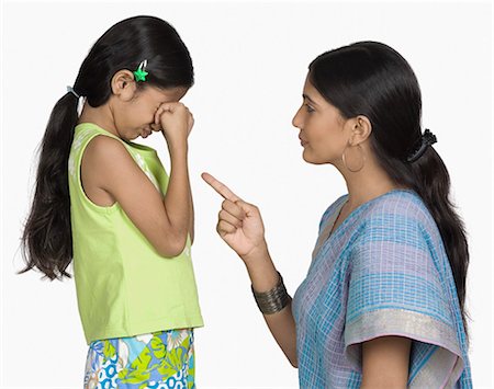 frustrated child white background - Side profile of a young woman scolding her daughter Stock Photo - Premium Royalty-Free, Code: 630-03479752