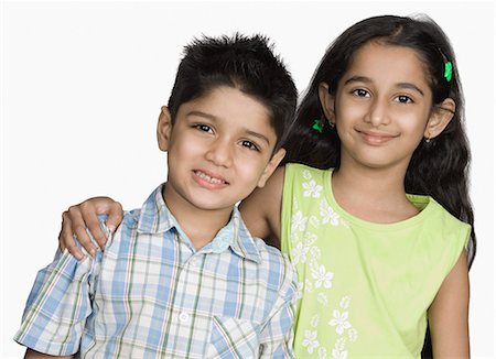 preteen boy happy white background - Close-up of a girl smiling with her brother Stock Photo - Premium Royalty-Free, Code: 630-03479770