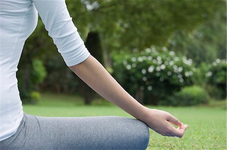 Woman practicing yoga in a park Stock Photo - Premium Royalty-Free, Code: 630-03479790
