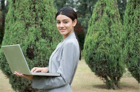 east indian teen girl - Businesswoman working on a laptop Stock Photo - Premium Royalty-Free, Code: 630-03479819