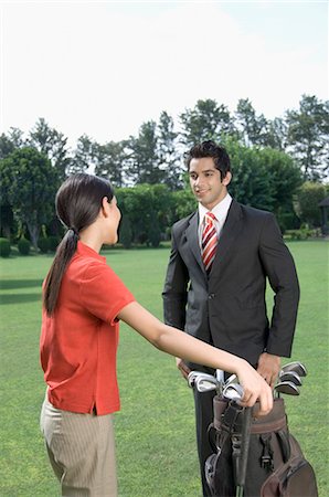 simsearch:630-03479937,k - Couple in a golf course Stock Photo - Premium Royalty-Free, Code: 630-03479899