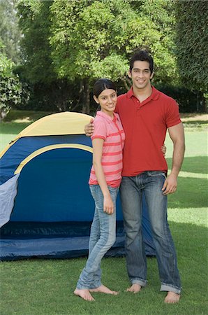smiling student india - Couple standing in a park and smiling Stock Photo - Premium Royalty-Free, Code: 630-03479914