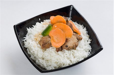 Close-up of meat with white rice in a bowl Stock Photo - Premium Royalty-Free, Code: 630-03479994