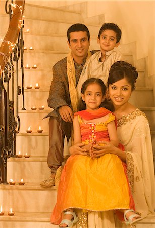 saree indian moms - Family sitting on a staircase and smiling Stock Photo - Premium Royalty-Free, Code: 630-03480228