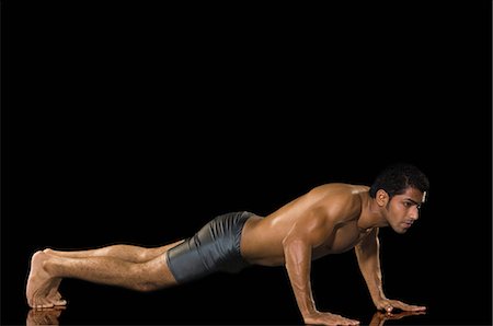 excercise black background - Man doing push-ups Stock Photo - Premium Royalty-Free, Code: 630-03480317