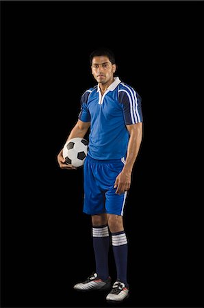 football portrait studio - Portrait of a man holding a soccer ball Stock Photo - Premium Royalty-Free, Code: 630-03480320