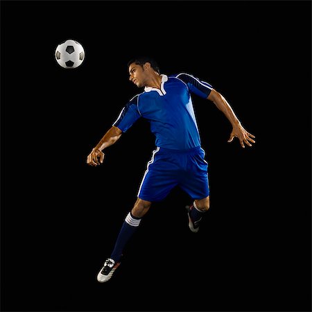 sock foot shoe - Man heading a soccer ball Stock Photo - Premium Royalty-Free, Code: 630-03480331