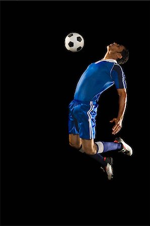 soccer goal with black background - Man playing soccer Stock Photo - Premium Royalty-Free, Code: 630-03480333